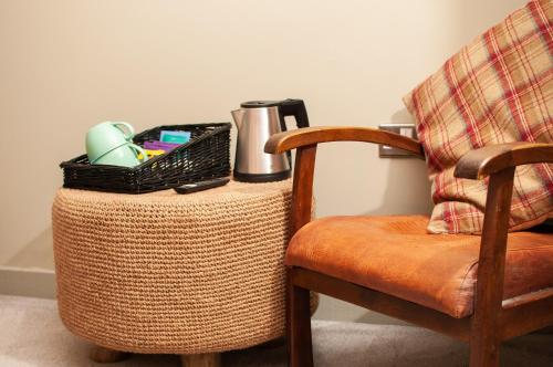 a basket on a wicker table next to a chair at The Wiremill in Felbridge