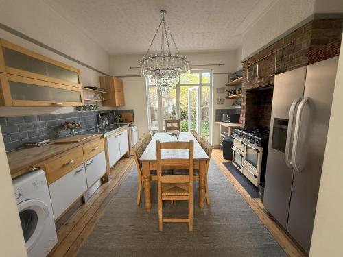a kitchen with a table and a dining room at Victorian Villa close to Liverpool City Centre in Liverpool