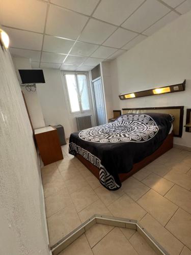 a bedroom with a bed and a mirror on the floor at Hotel Gambetta in Marseille