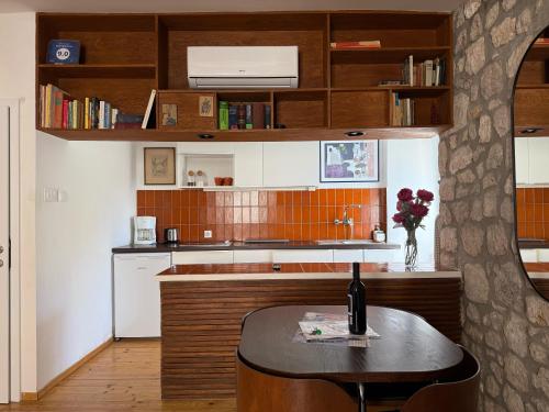 a kitchen with a table with a bottle of wine at Apartment Naval in Dubrovnik