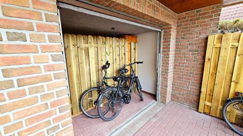 two bikes are parked in a brick building at Ferienwohnung "Friesentied" 35229 in Hesel