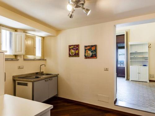 a kitchen with a sink and a ceiling fan at Porticciolo sea view in Aci Castello