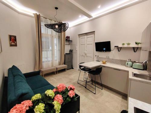 un salon avec un canapé vert et une cuisine dans l'établissement Apartment Cosy in Montpellier, à Montpellier