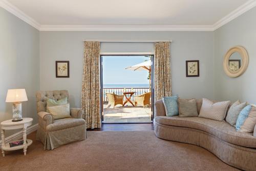 a living room with a couch and a chair at Buccara Noetzie - Pezula Castle in Knysna