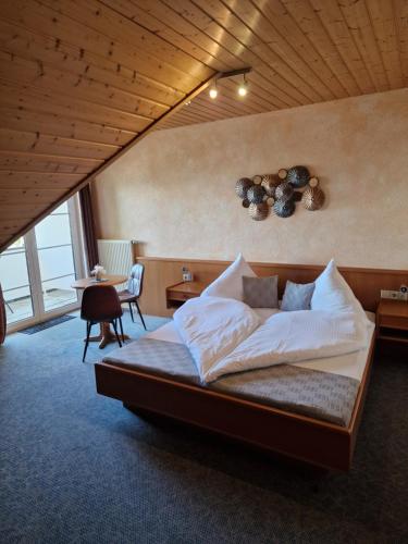 a bedroom with a large bed in a room at Hotel Klett B&B in Langenargen