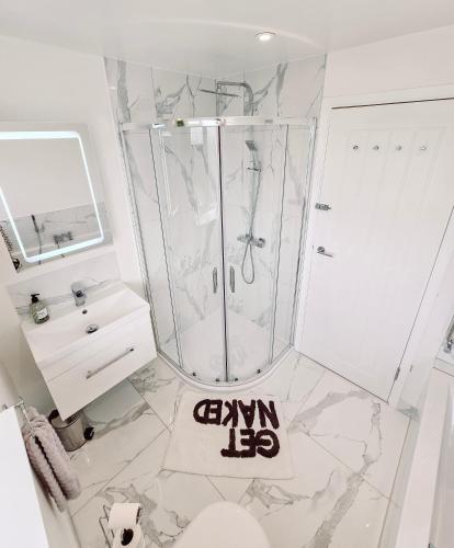 a bathroom with a shower and a sink at Luxury Sea View Retreat with Hot Tub Sleeps 8 in Dover