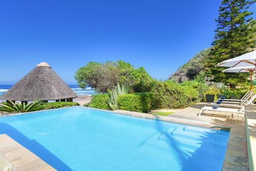 a swimming pool with a view of the ocean at Buccara Noetzie - Pezula Castle in Knysna
