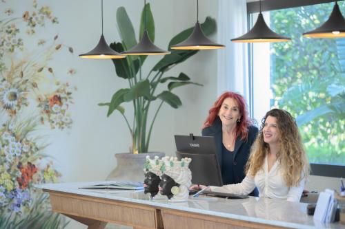 two women sitting at a desk in an office at Villa Felicia in Noto