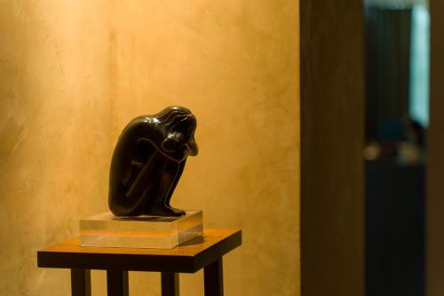 a statue of a woman sitting on a table at les suites taipei ching cheng in Taipei