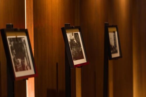 a row of framed photographs on a wall at les suites taipei ching cheng in Taipei