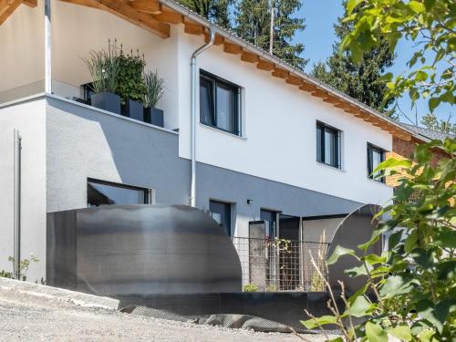 an external view of a house with a large metal object at Ländle Lodge bei Bregenz in Langen bei Bregenz