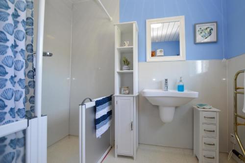 a bathroom with a sink and a toilet and a mirror at Bay View in Lochgilphead