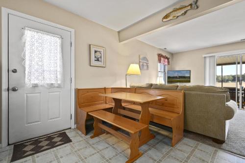 a living room with a table and a couch at Island Retreat in Birch Town