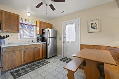 a kitchen with a refrigerator and a wooden table at Island Retreat in Birch Town