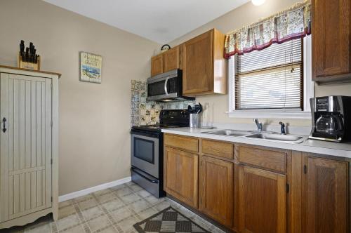a kitchen with a sink and a stove at Island Retreat in Birch Town