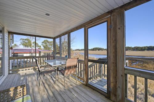 a porch of a house with a table and chairs at Island Retreat in Birch Town