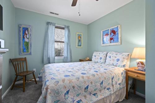 a bedroom with a bed and a desk and a window at Island Retreat in Birch Town