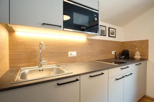 a kitchen with a sink and a microwave at Apartment MarLen in Eben am Achensee