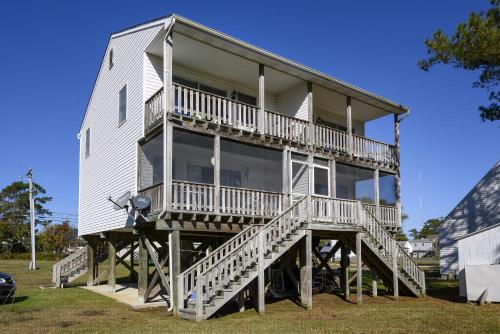 a large white house with a large deck at Sea Treasure in Chincoteague