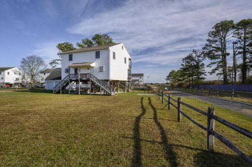 a long shadow of a house with a fence at Sea Treasure in Chincoteague