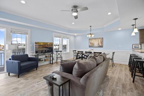 a living room with a couch and a table at At The Waters Edge in Chincoteague