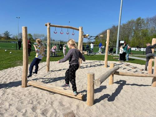 a group of children playing on a playground at Helle Aktivitetshotel in Årre