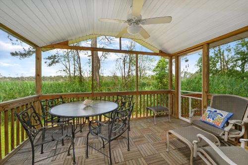 a screened in porch with a table and chairs at Catch Of The Day in Deep Hole