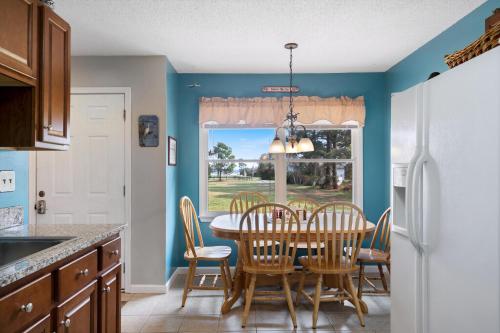 a kitchen with a table and chairs and a window at Catch Of The Day in Deep Hole