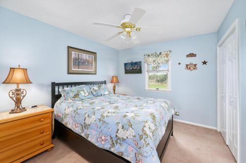 a bedroom with a bed and a ceiling fan at Catch Of The Day in Deep Hole