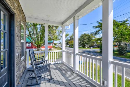 a porch with a rocking chair on a house at Saltwater Pony in Black Point Landing