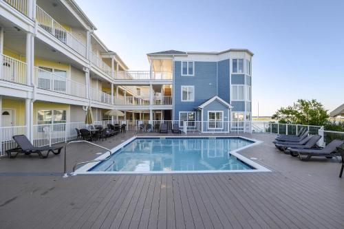 a swimming pool in front of a building at Sunset Bay Villa 220 - Vista Costiera in Chincoteague