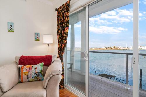 a living room with a couch and a large window at Sunset Bay Villa 220 - Vista Costiera in Chincoteague