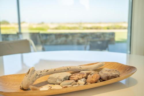 a wooden plate with different types of mushrooms on a table at Villa Partenope in Favignana