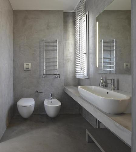 a bathroom with a white sink and a toilet at Villa Partenope in Favignana