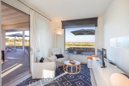 a living room with a view of a balcony at Villa Partenope in Favignana