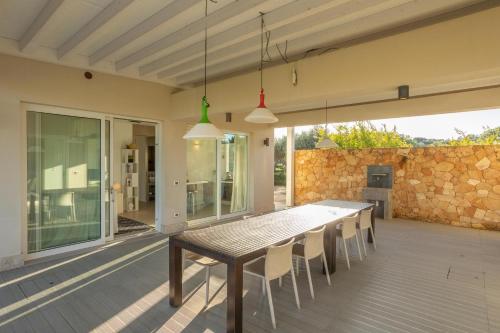 a wooden table and chairs on a patio at Villa Partenope in Favignana