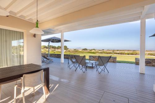 a patio with chairs and a table and a view at Villa Partenope in Favignana
