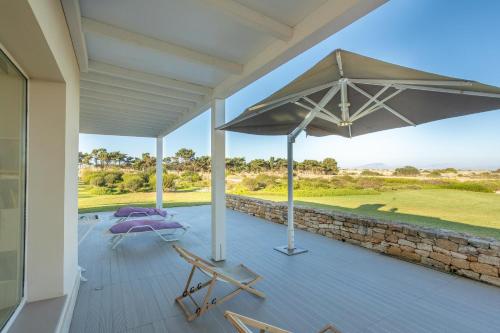 an umbrella on the deck of a house at Villa Partenope in Favignana