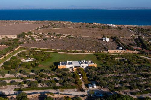an aerial view of a house on a hill next to the ocean at Villa Partenope in Favignana