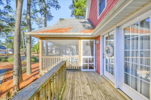 a front porch of a home with a wooden deck at Whispering Pines in Black Point Landing