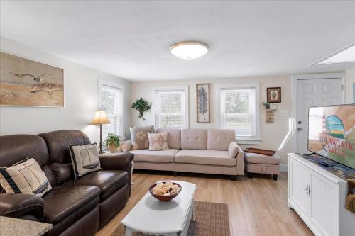 a living room with a couch and a table at Love And Luck in Birch Town