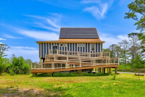 a house with solar panels on the roof at House On The Dune in Deep Hole