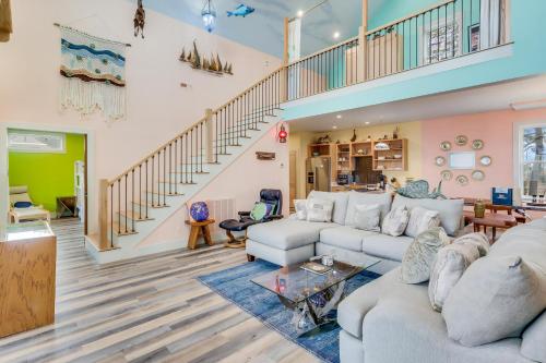 a living room with couches and a staircase at House On The Dune in Deep Hole