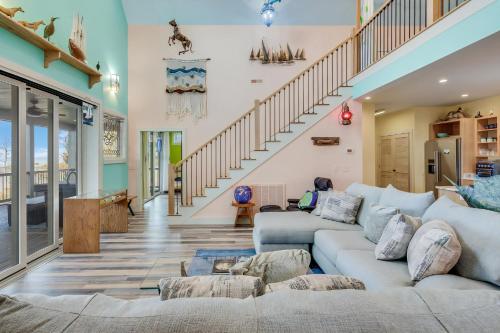 a living room with a couch and a staircase at House On The Dune in Deep Hole