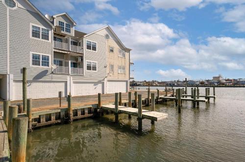 a house on a dock next to a body of water at Ducks, Docks, And Flip Flops in Chincoteague