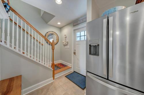 a kitchen with a refrigerator and a staircase at Eventide in Black Point Landing