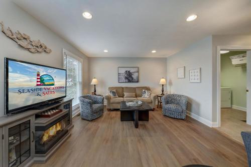a living room with a flat screen tv and a couch at Eventide in Black Point Landing
