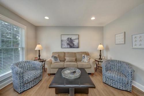 a living room with a couch and two chairs at Eventide in Black Point Landing
