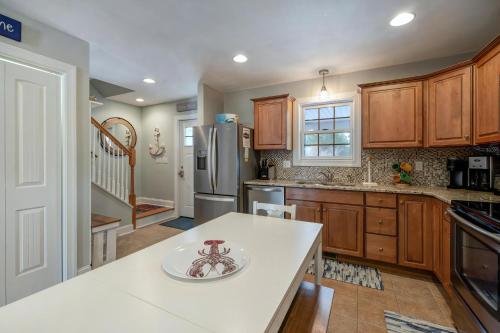 a kitchen with wooden cabinets and a white counter top at Eventide in Black Point Landing