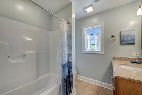 a bathroom with a shower and a sink at Eventide in Black Point Landing
